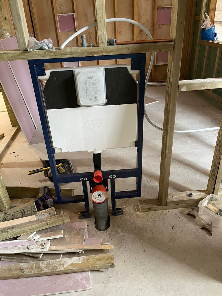Wall-mounted blue toilet frame with white tank and black seat in a construction bathroom setting