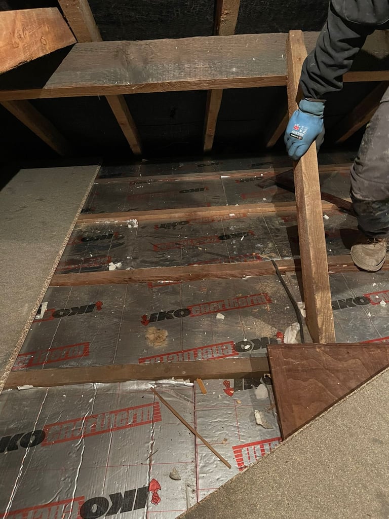 Person examining open wooden furniture frame with insulation material visible inside the cavity